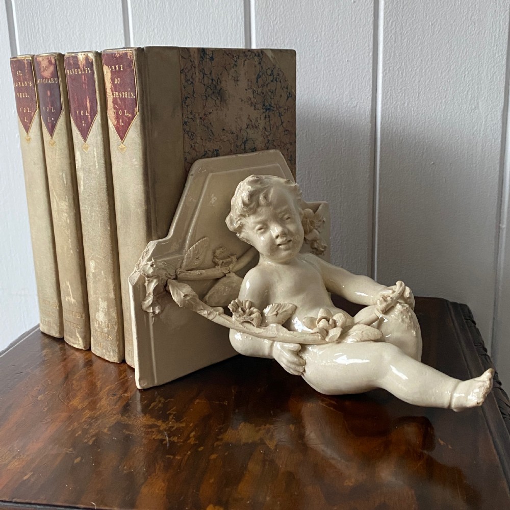 A Vintage French Ceramic Wall Bracket or Book End In The Form Of A Cherub