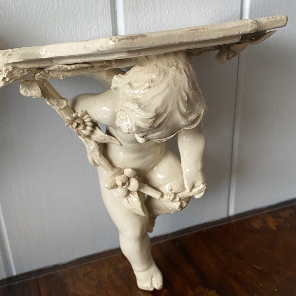 A Vintage French Ceramic Wall Bracket or Book End In The Form Of A Cherub View IV