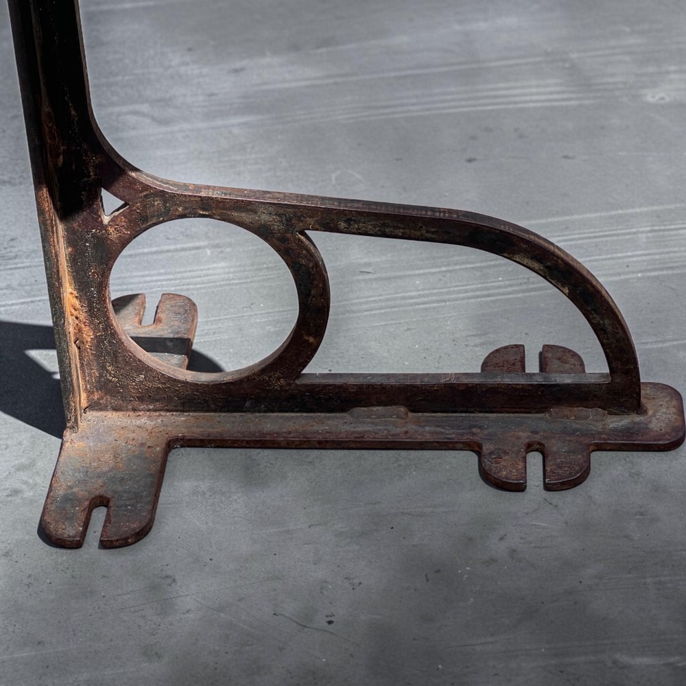 A set of four industrial machinist stools with sculpted pitch pine seats and dark cast iron cantilever bases. View IV