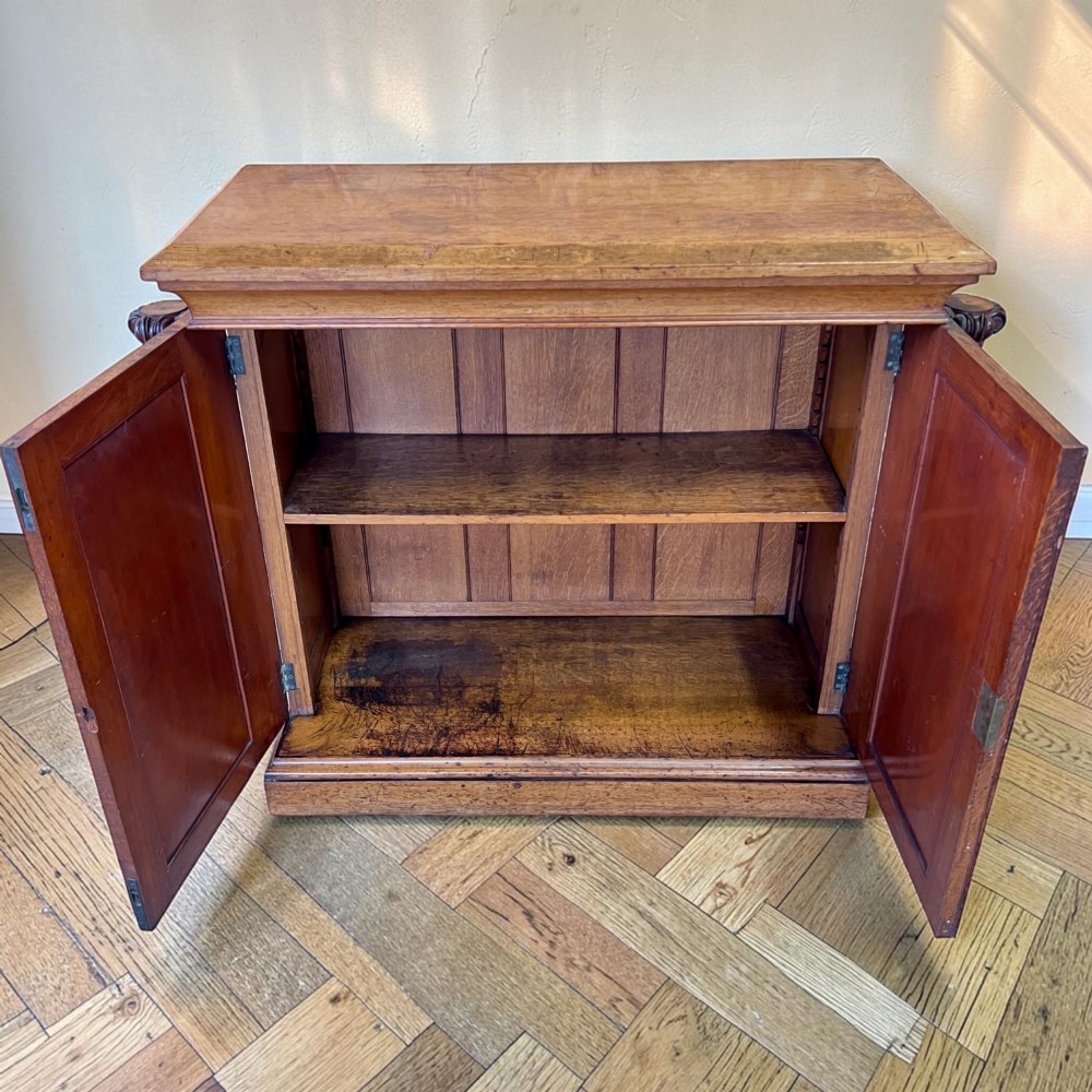 A William IV Gothic Revival oak side cabinet featuring twin pointed-arch panelled doors flanked by turned columns. View III