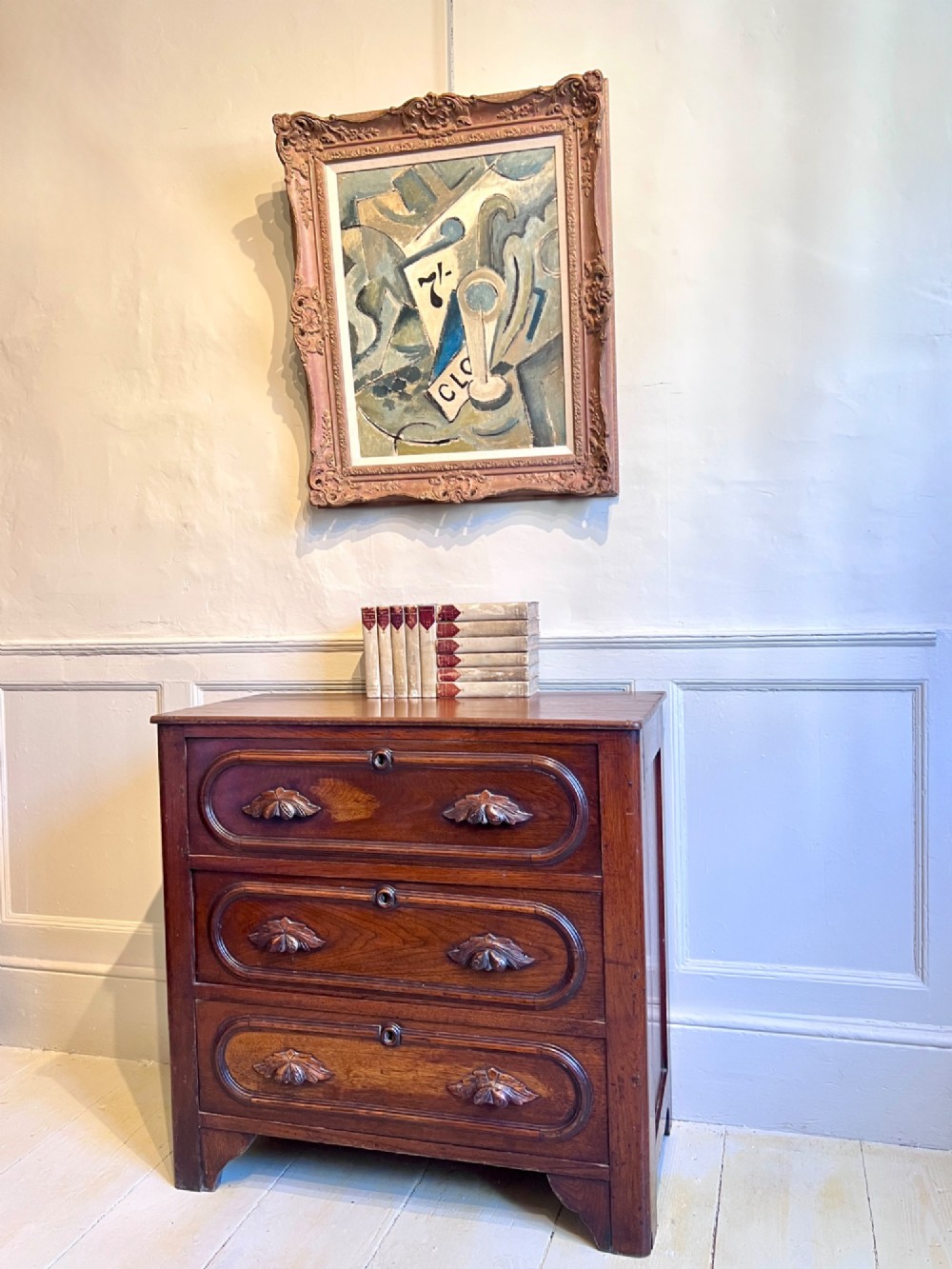 A late nineteenth-century American oak chest featuring three drawers with oval moulding and carved wooden foliate handles. View III