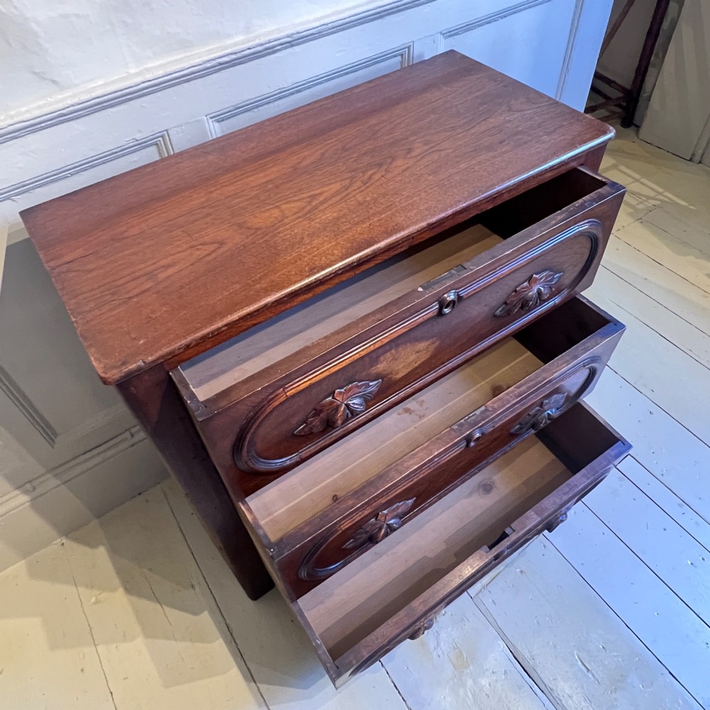 A late nineteenth-century American oak chest featuring three drawers with oval moulding and carved wooden foliate handles. View VI