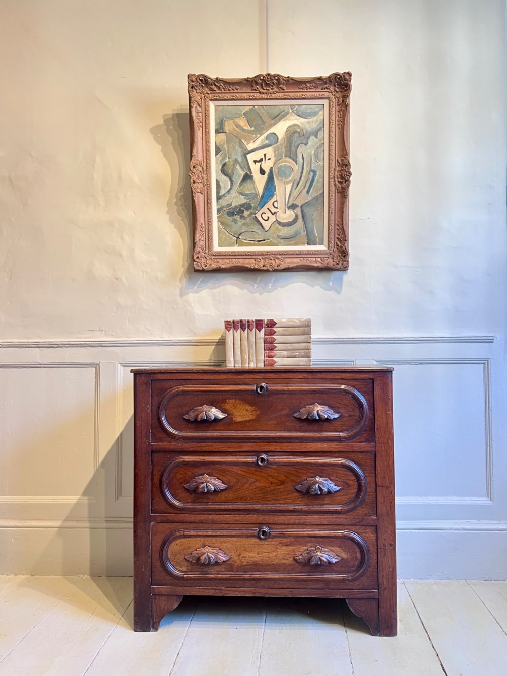 A late nineteenth-century American oak chest featuring three drawers with oval moulding and carved wooden foliate handles. View VII
