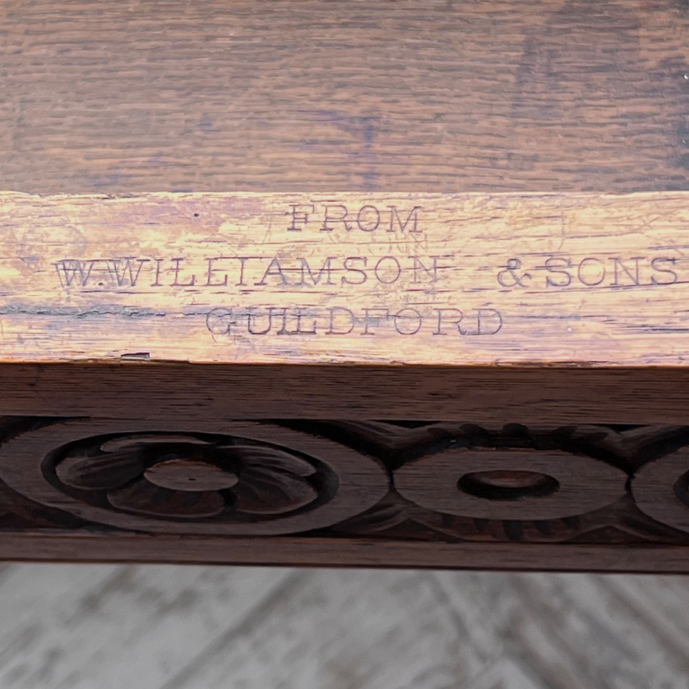 An octagonal Victorian oak centre table featuring a carved rosette frieze, barley twist legs, a central finial stretcher, and an inset leather top. View IX