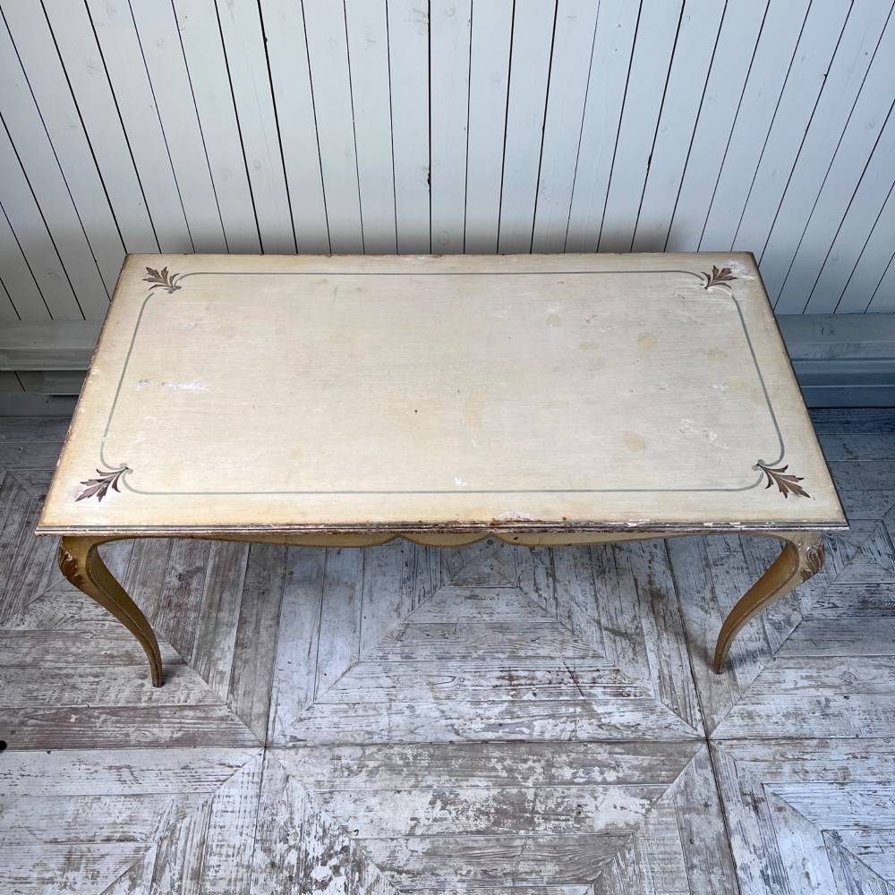 A rectangular French Louis XV Revival dining table featuring a cream painted finish, gold leaf accents, curved cabriole legs, and a scalloped apron. View VI