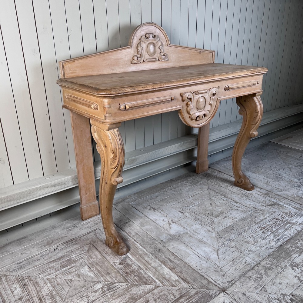 A Victorian carved pine console table featuring front cabriole legs, a central relief cartouche, and a shaped gallery backrest. View II