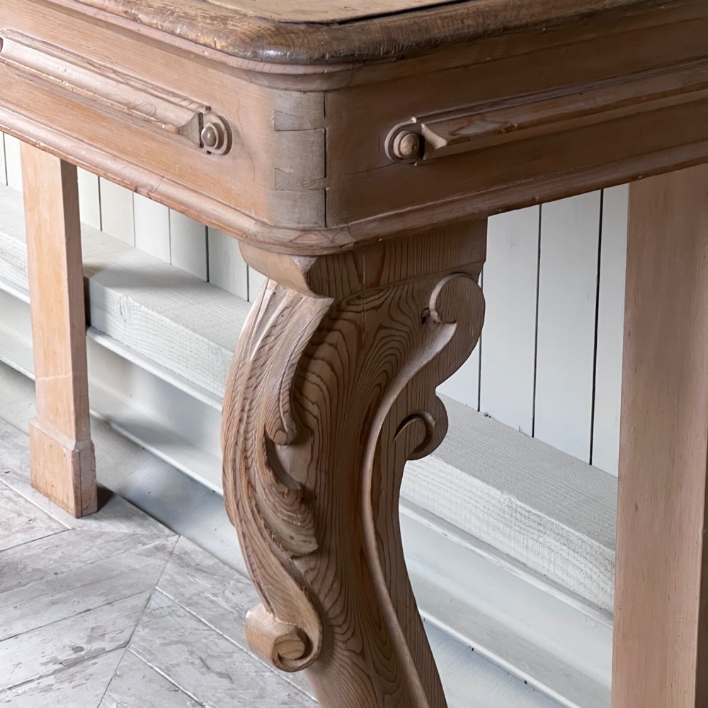 A Victorian carved pine console table featuring front cabriole legs, a central relief cartouche, and a shaped gallery backrest. View VII