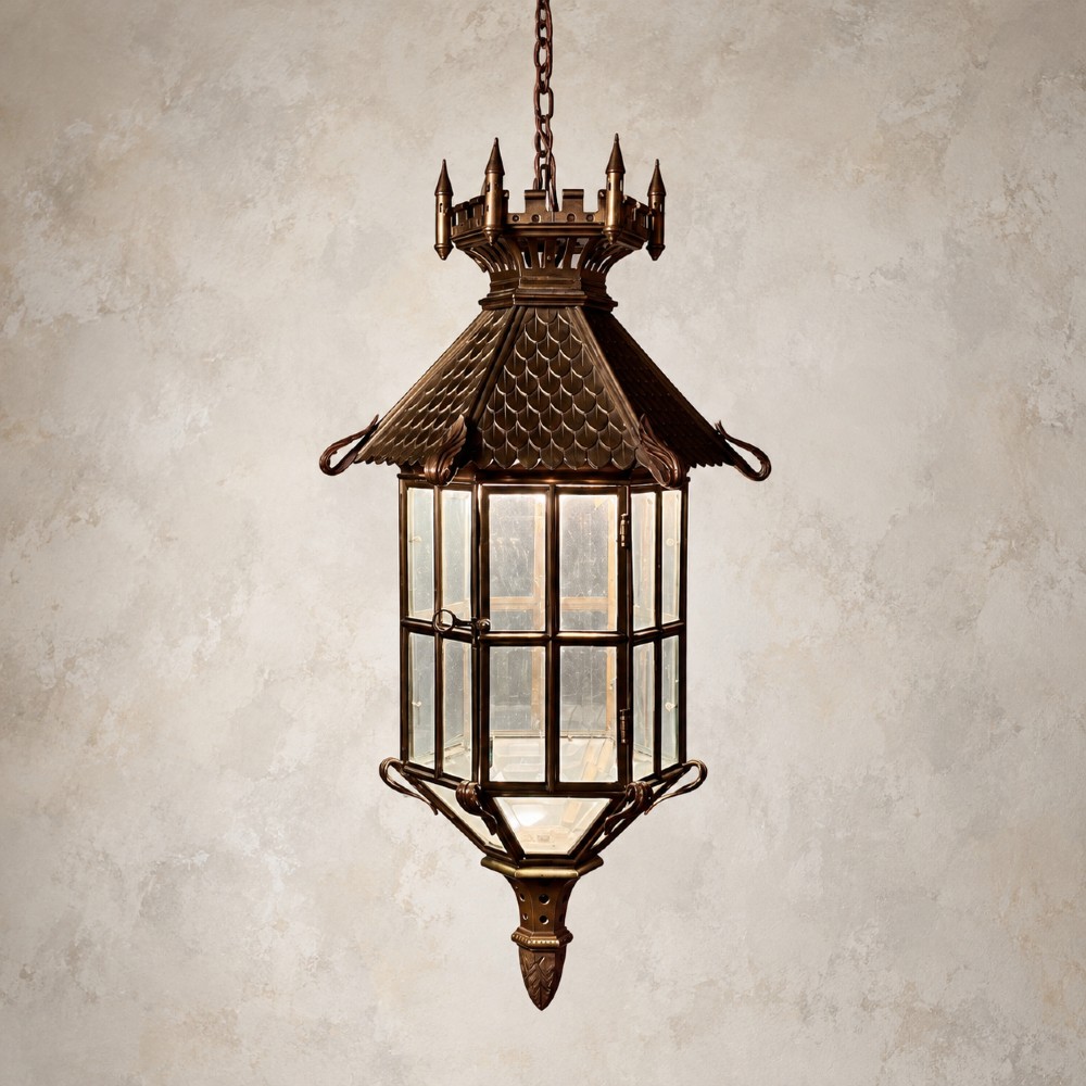 A large Continental Gothic Revival bronze hanging lantern featuring a castellated crown roof with turrets, scale detailing, and glass panels. View IV
