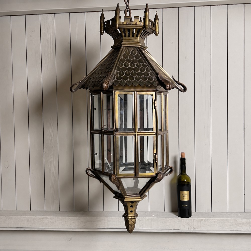A large Continental Gothic Revival bronze hanging lantern featuring a castellated crown roof with turrets, scale detailing, and glass panels. View V