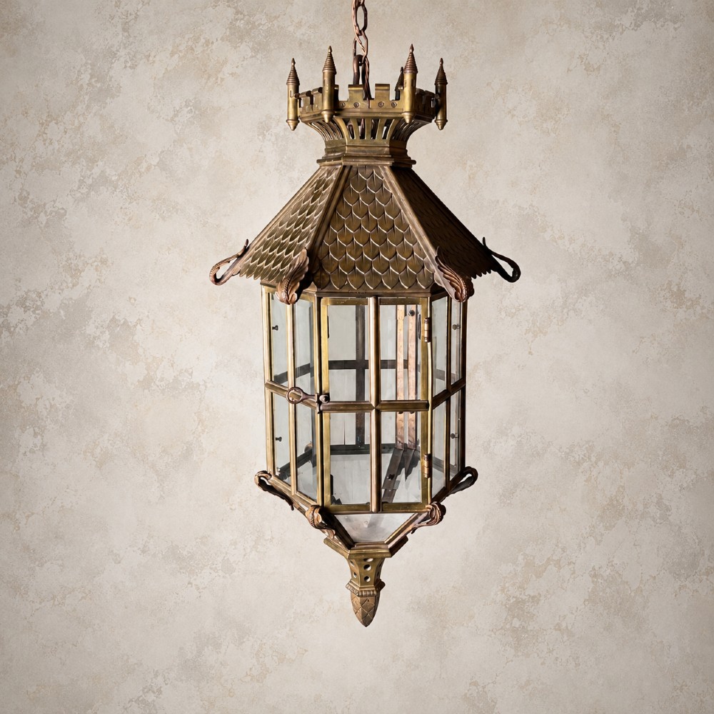 A large Continental Gothic Revival bronze hanging lantern featuring a castellated crown roof with turrets, scale detailing, and glass panels. View VI