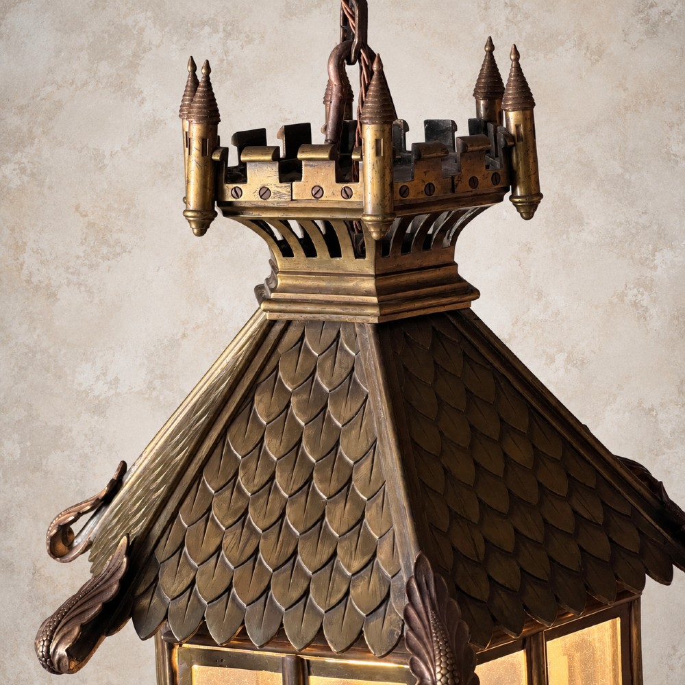A large Continental Gothic Revival bronze hanging lantern featuring a castellated crown roof with turrets, scale detailing, and glass panels. View VIII