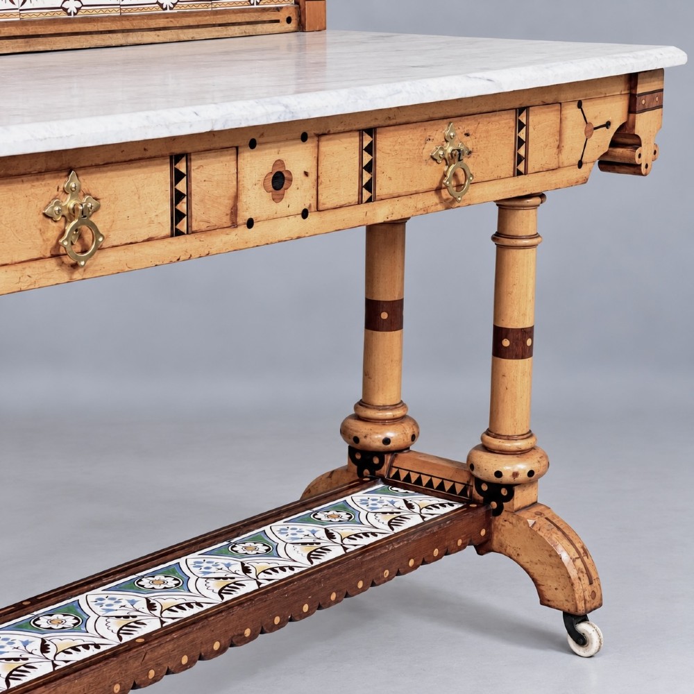 A Victorian Reformed Gothic washstand featuring a white marble top, turned legs, a tiled splashback, and geometric dark wood inlays. View V