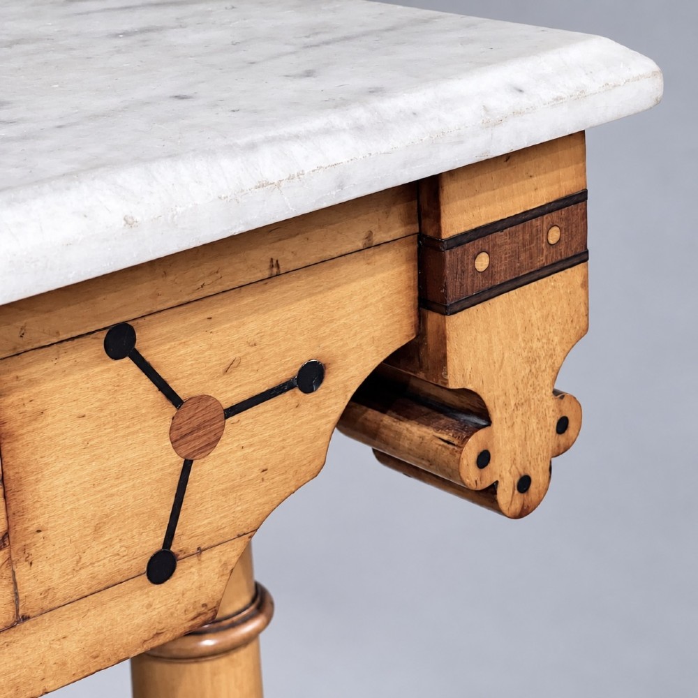 A Victorian Reformed Gothic washstand featuring a white marble top, turned legs, a tiled splashback, and geometric dark wood inlays. View VI