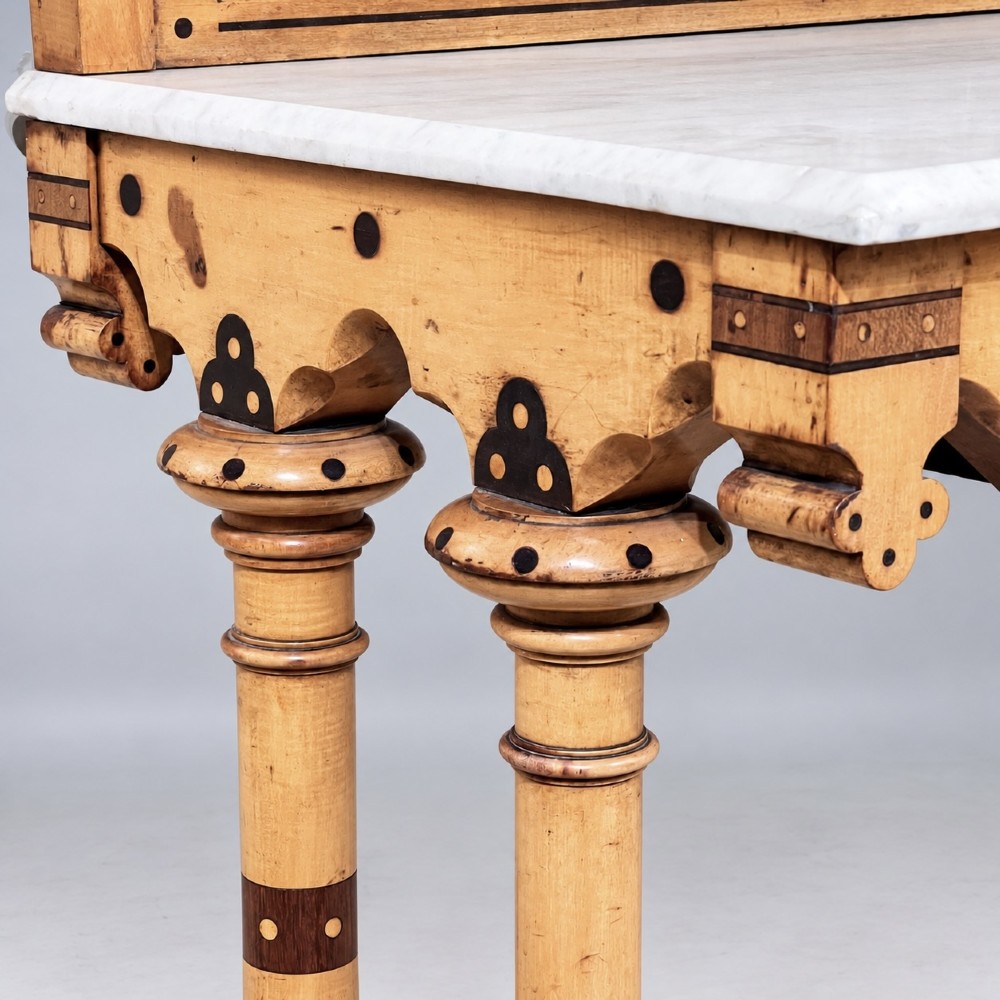 A Victorian Reformed Gothic washstand featuring a white marble top, turned legs, a tiled splashback, and geometric dark wood inlays. View VII