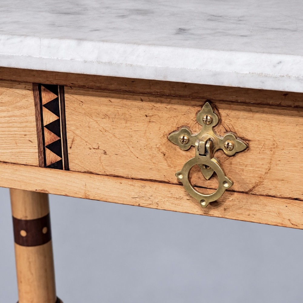 A Victorian Reformed Gothic washstand featuring a white marble top, turned legs, a tiled splashback, and geometric dark wood inlays. View VIII