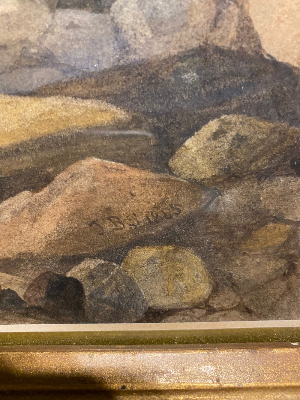 A framed 19th-century watercolour painting depicting fishermen on a rocky shore beside stormy seas, enclosed in an ornate gilded frame. View II