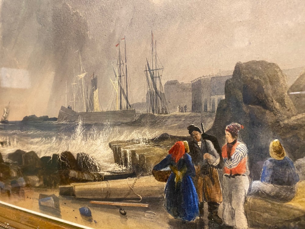 A framed 19th-century watercolour painting depicting fishermen on a rocky shore beside stormy seas, enclosed in an ornate gilded frame. View III