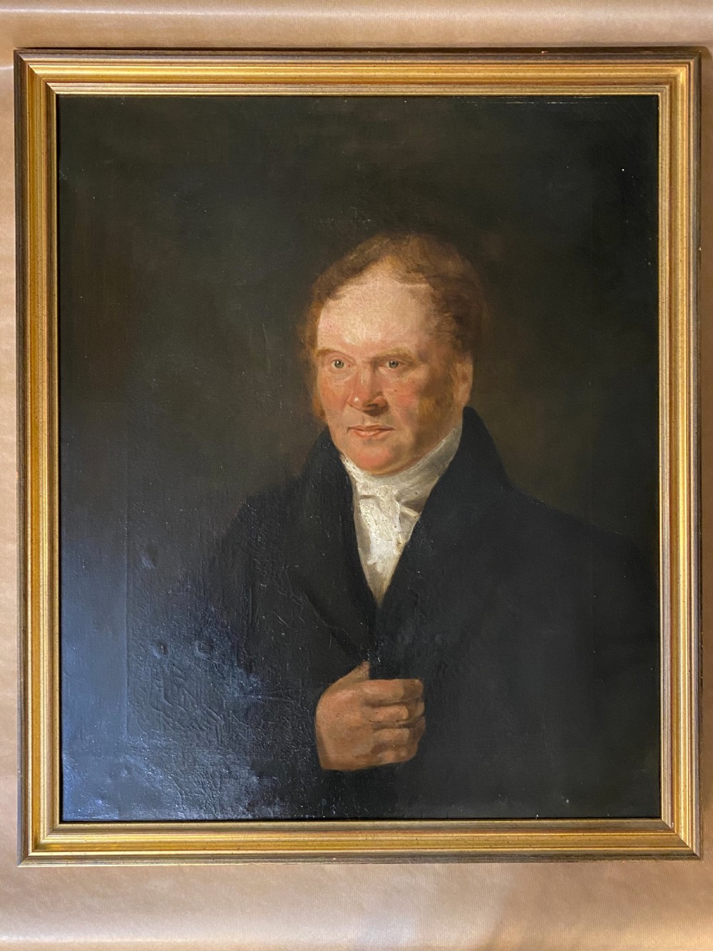 A 19th-century oil painting on canvas depicting a red-haired gentleman in a black coat and white cravat, set inside a gold gilt frame.