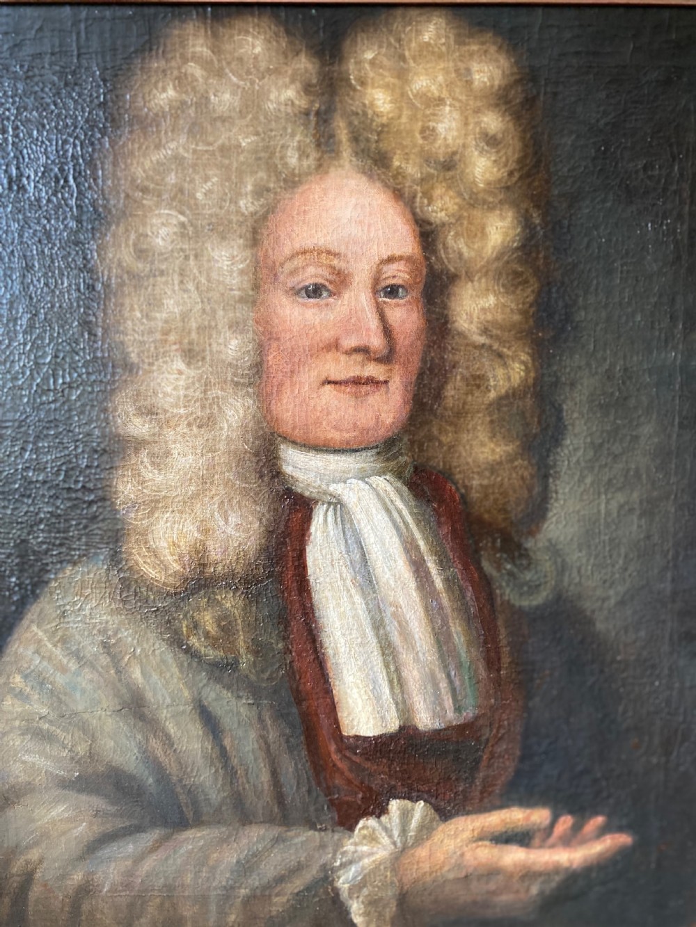 An 18th-century oil painting depicting a gentleman wearing a powdered wig and white cravat, framed within a wide oak wood border. View II