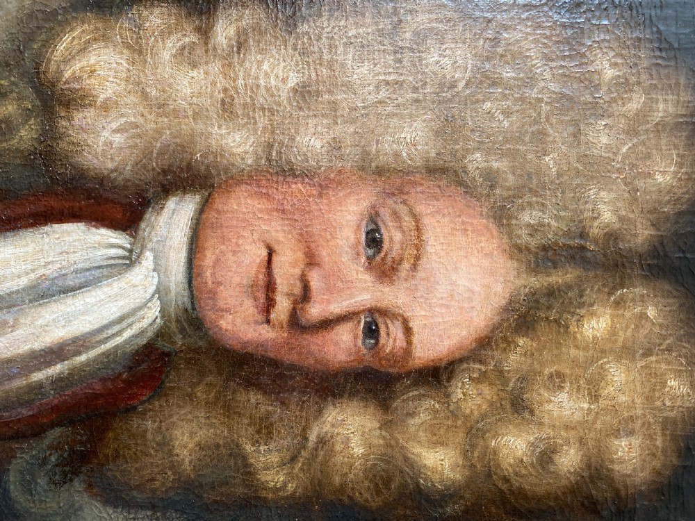 An 18th-century oil painting depicting a gentleman wearing a powdered wig and white cravat, framed within a wide oak wood border. View VIII