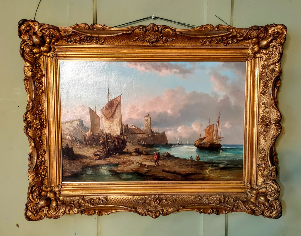 A 19th-century oil painting depicting fishermen and sailing vessels in a coastal harbour, housed in an ornate gilt swept frame. View VI