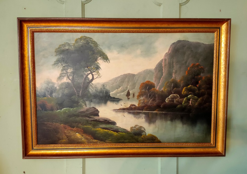 A framed oil painting depicting a peaceful river winding between hills and steep cliffs, with birds flying near the water under a soft atmospheric sky.