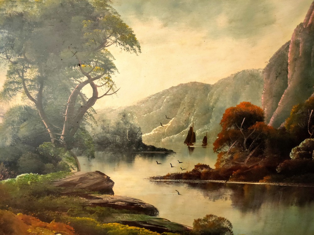 A framed oil painting depicting a peaceful river winding between hills and steep cliffs, with birds flying near the water under a soft atmospheric sky. View II