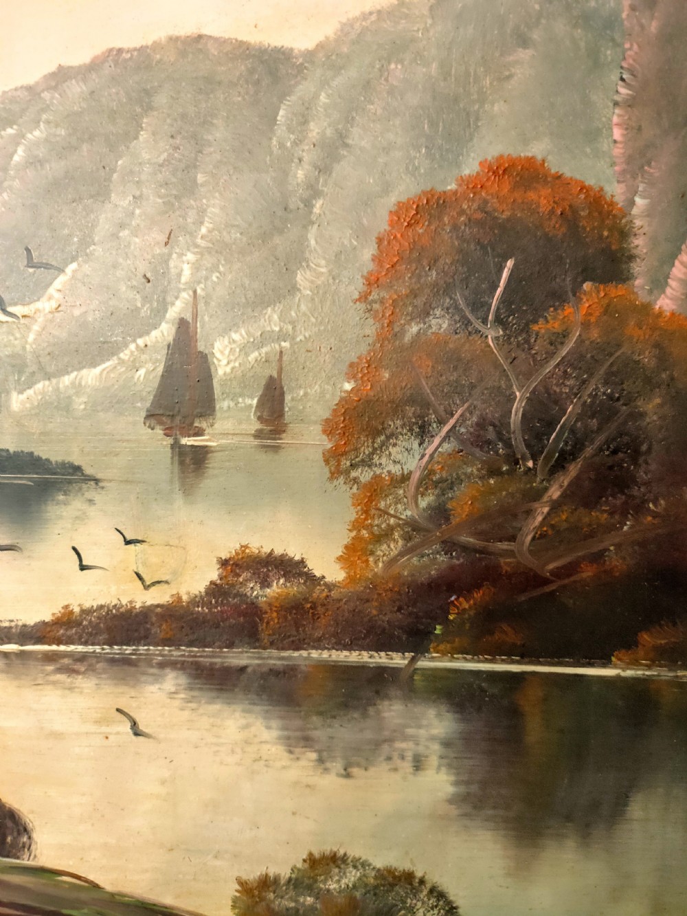 A framed oil painting depicting a peaceful river winding between hills and steep cliffs, with birds flying near the water under a soft atmospheric sky. View III