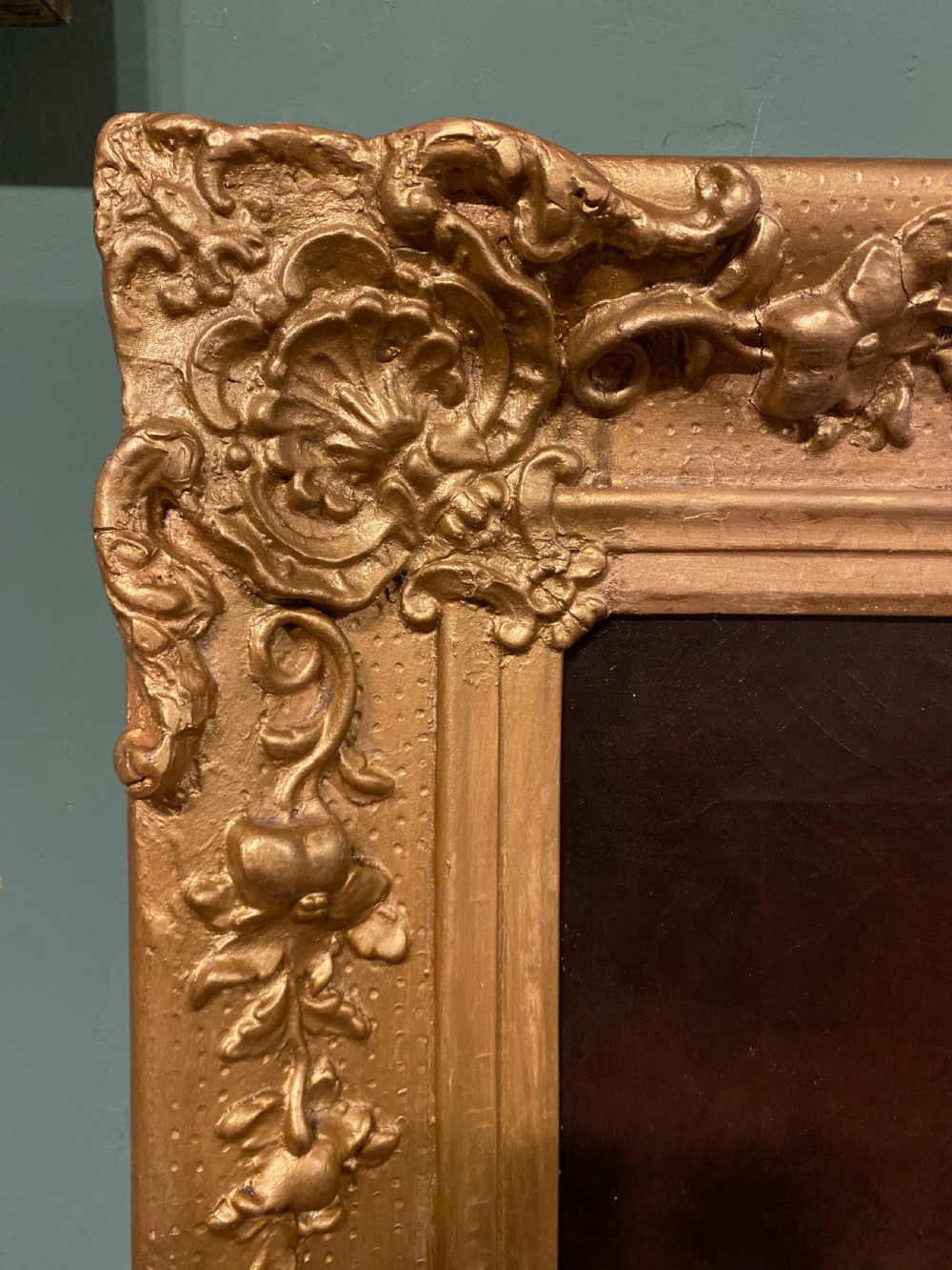 A 19th-century oil painting on canvas depicting a seated gentleman in black formal wear, set within an ornate gilded frame. View V