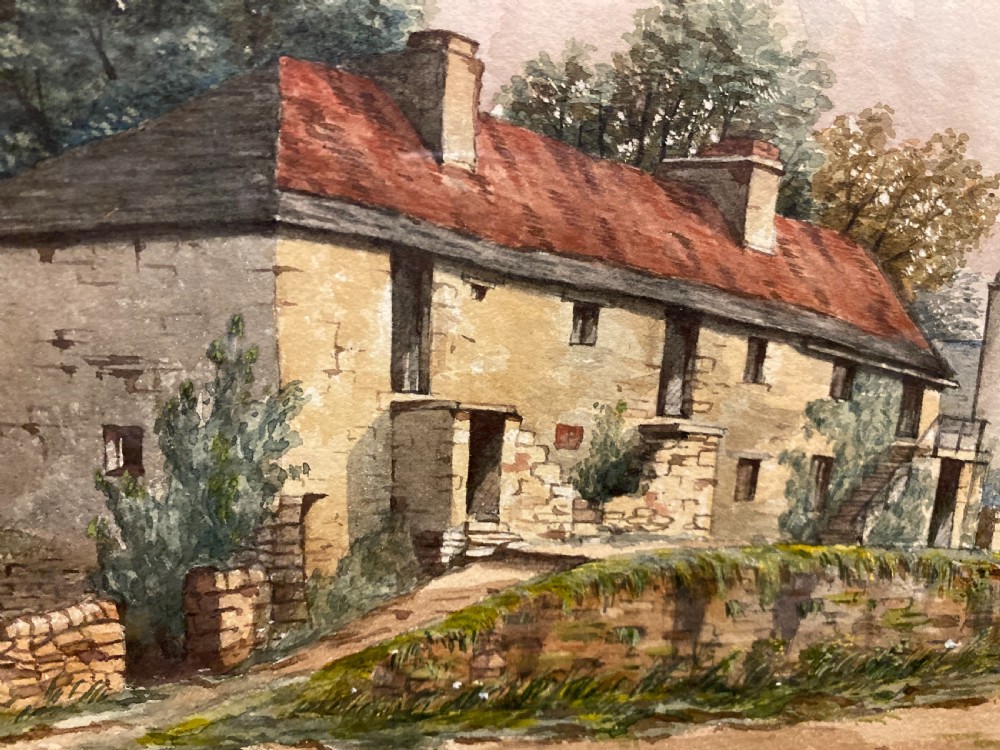 A framed watercolour painting depicting stone cottages and countryside terrain, displayed within a wide mount and slender gilt frame. View III