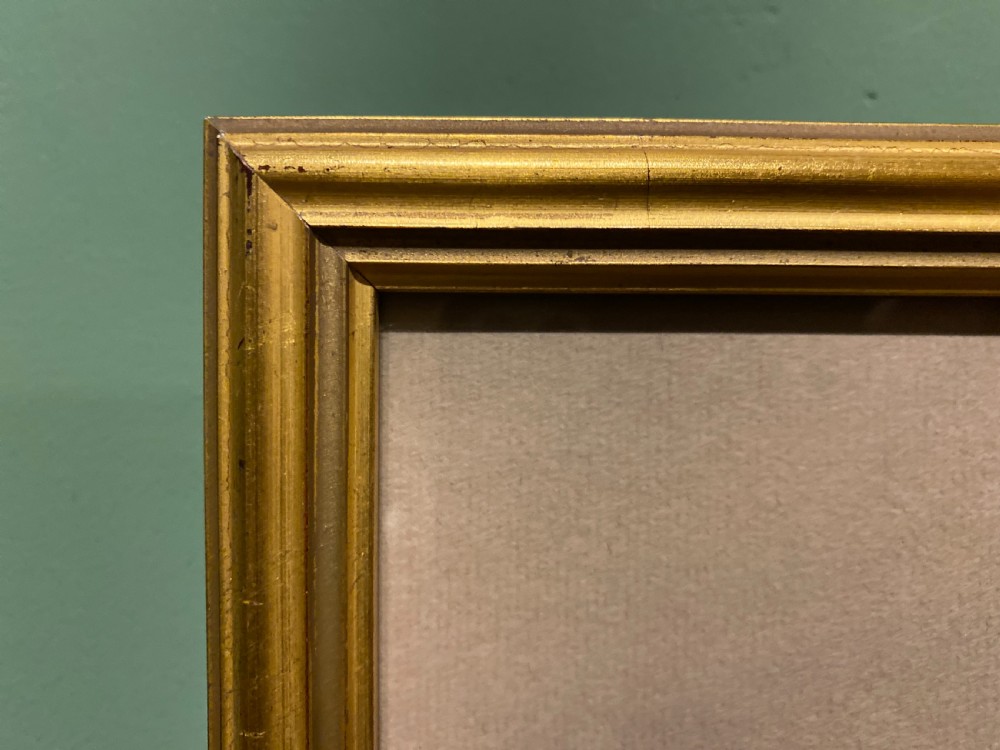 A framed watercolour painting depicting stone cottages and countryside terrain, displayed within a wide mount and slender gilt frame. View IV