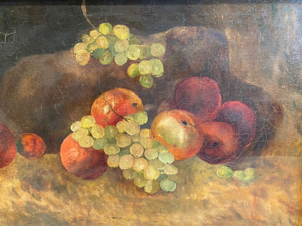A framed oil painting depicting green grapes and red apples arranged on a tabletop against a dark background. View VI