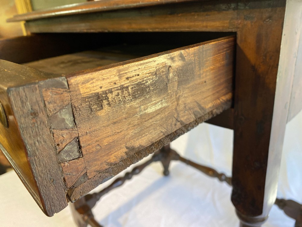 A mid-18th century walnut dresser base featuring two drawers with brass handles, supported on slender legs with pad feet. View V