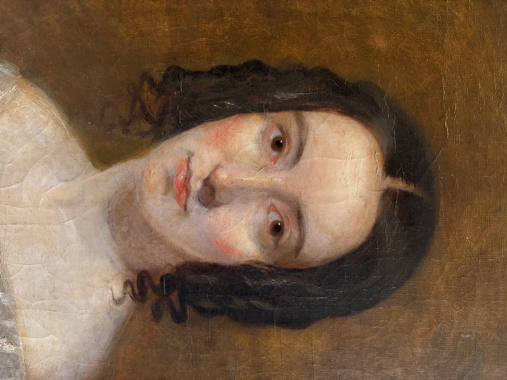 A mid-19th-century oil painting on canvas depicting a seated lady in a light blue dress with a lace collar, set inside a heavy gilded rectangular frame. View IV