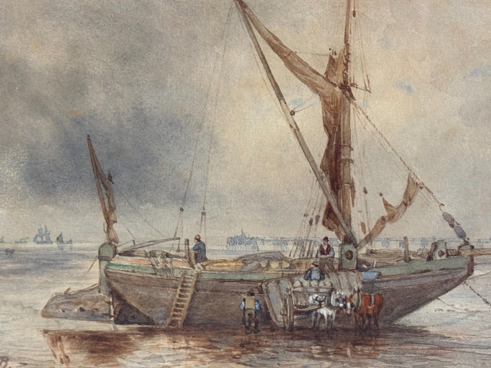 A 19th-century nautical watercolour depicting a wooden sailing vessel anchored in calm waters, enclosed in a cream mount and dark wooden frame with a carved gilt inner slip. View V