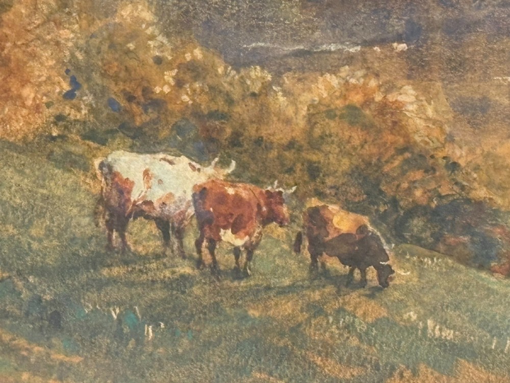 A framed Victorian watercolour painting by Robert Thorne Waite depicting cattle grazing beside a river in a pastoral landscape, set within a wide mount and a fluted gilt frame. View VI