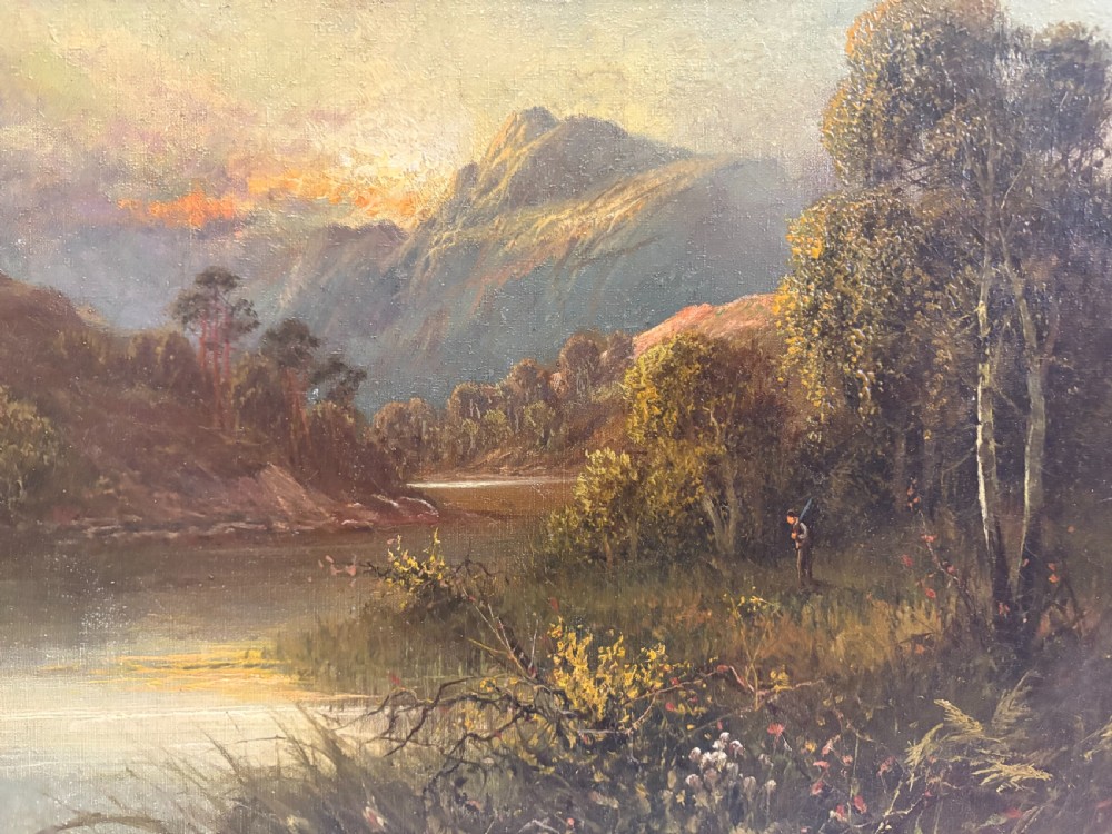 An antique oil painting on canvas depicting a mountainous lake landscape at sunset, housed in an ornate gilt frame. View VI