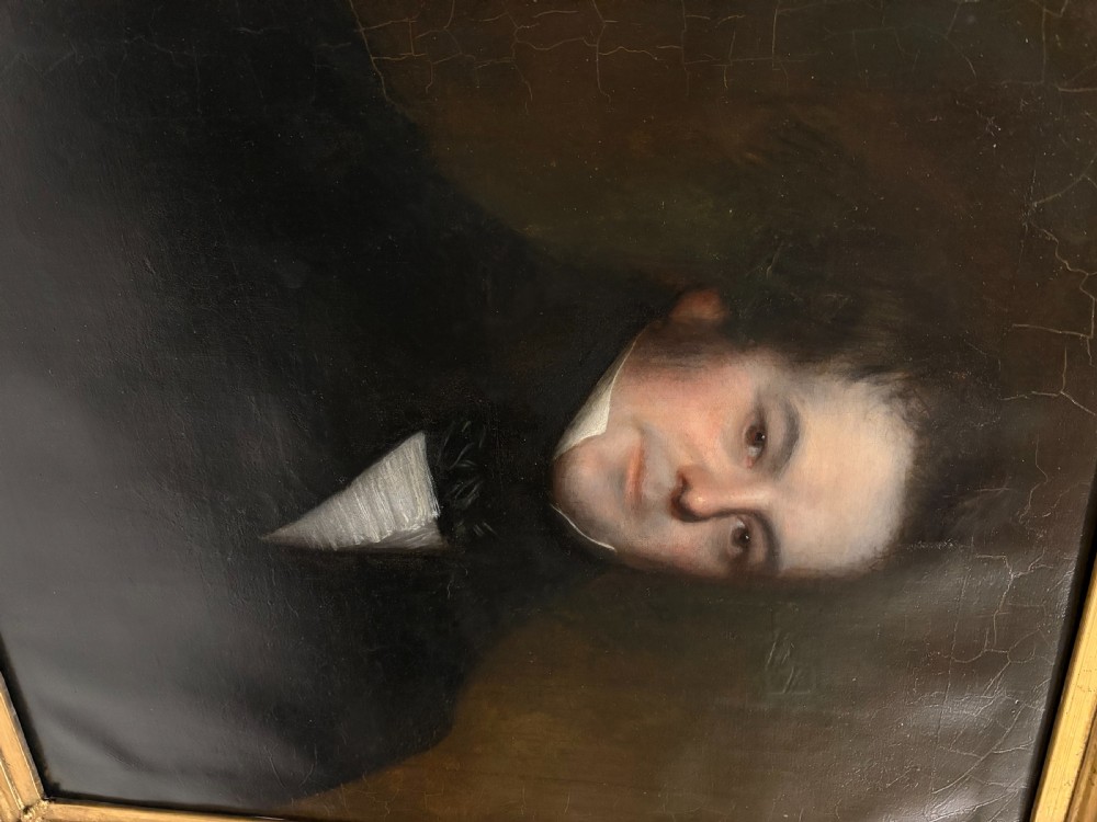 An early nineteenth-century oil portrait painting of a gentleman set inside an ornate gilt frame. View VI