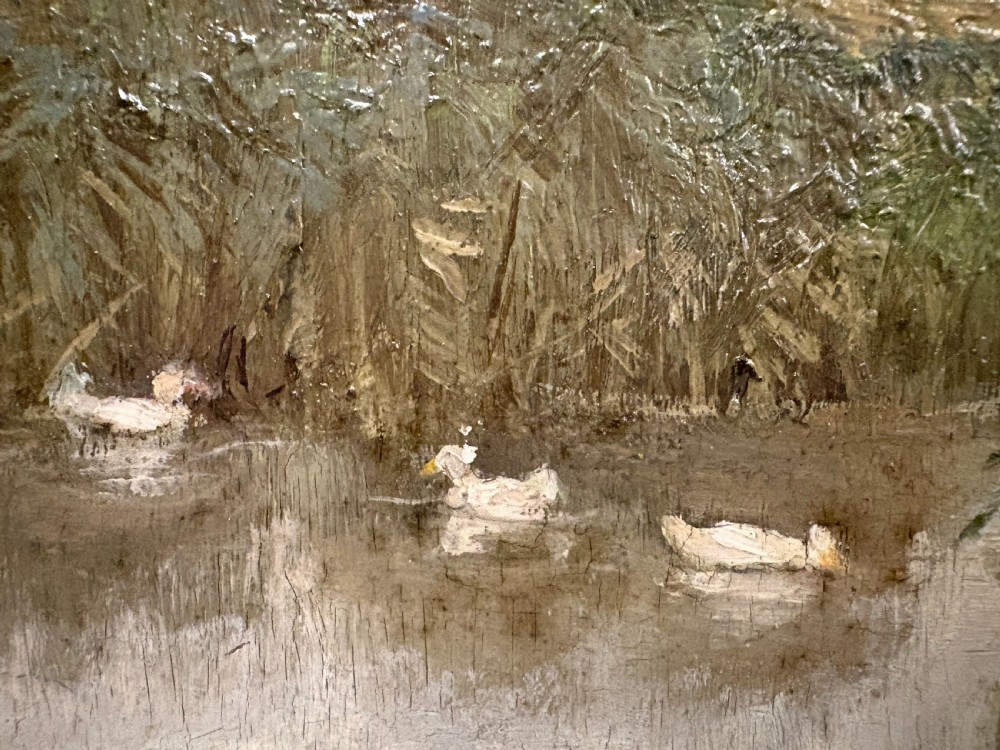 An oil painting depicting a rural landscape with geese swimming in a pond beside a dirt path under a large leafy tree, set in a carved gilt frame. View VI