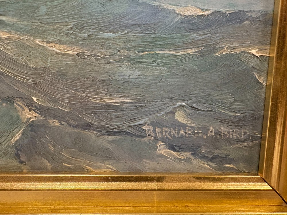 A framed 1930s oil painting on board depicting a tall sailing ship navigating rough blue-green ocean waters under a cloudy sky. View IV