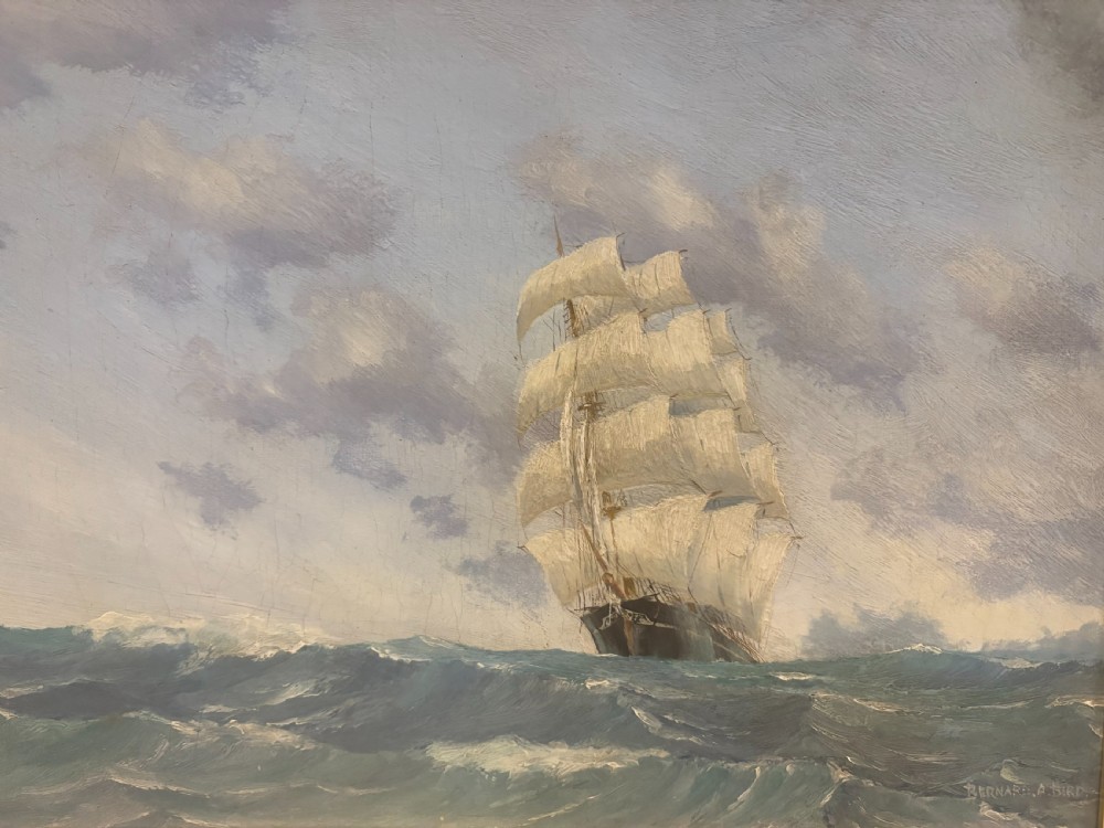 A framed 1930s oil painting on board depicting a tall sailing ship navigating rough blue-green ocean waters under a cloudy sky. View VI