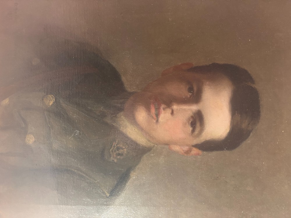 A framed 1917 oil portrait depicting a young First World War soldier in uniform set within a wide wooden frame. View V