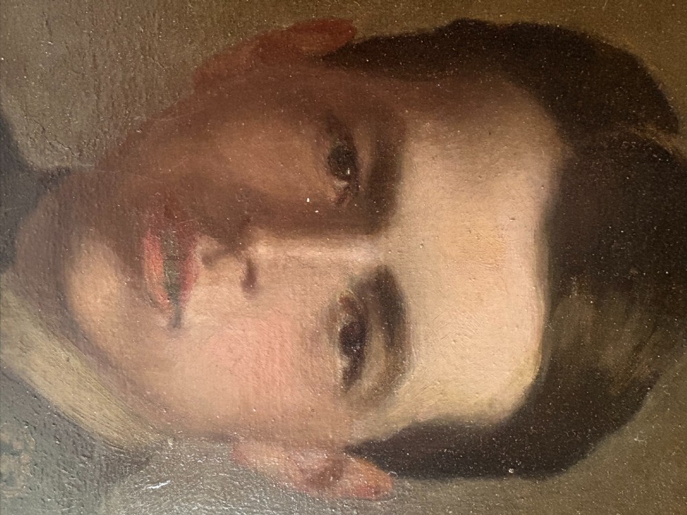 A framed 1917 oil portrait depicting a young First World War soldier in uniform set within a wide wooden frame. View VI