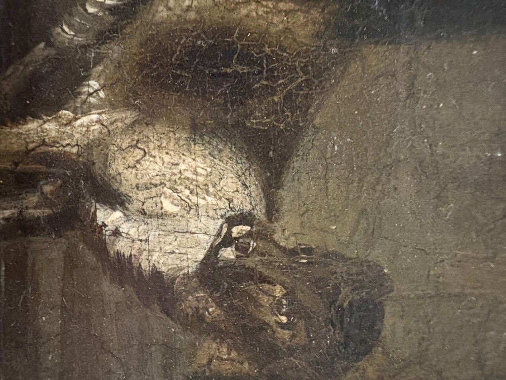 A 19th-century narrative oil painting depicting a master seated at a desk inside a dimly lit interior, set within a black ebonised frame with a gilded slip. View VI