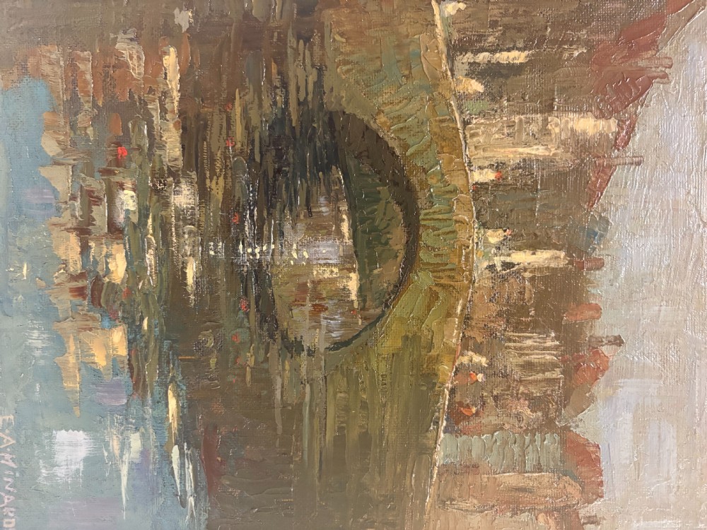 A framed 1940s oil painting depicting a stone arched bridge over a reflective canal surrounded by continental town buildings in muted tones. View V