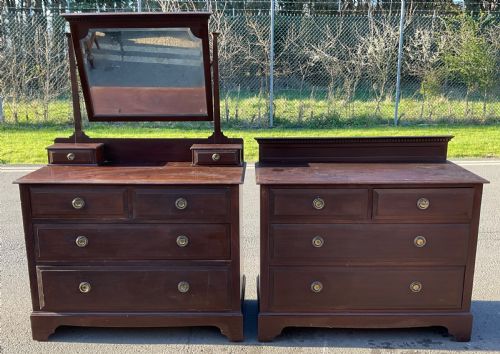 fig 1. A pair of dark Edwardian mahogany furniture pieces featuring a dressing chest with a tilting mirror alongside a matching chest of drawers.