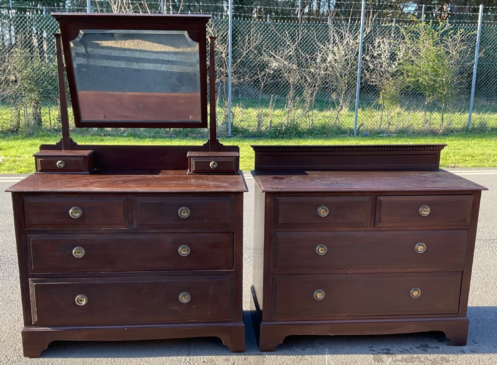 A pair of dark Edwardian mahogany furniture pieces featuring a dressing chest with a tilting mirror alongside a matching chest of drawers. View III