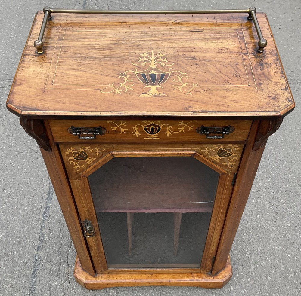 A Victorian walnut sheet music cabinet featuring floral marquetry inlay, a single glazed door with internal partitions, a top drawer, and a brass gallery rail. View III