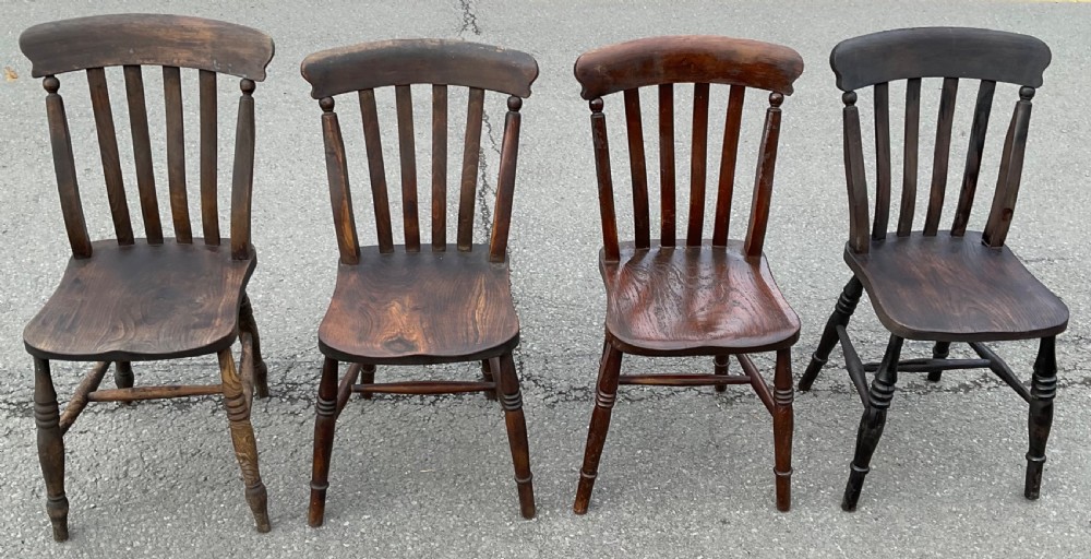 A set of four dark brown Victorian wooden lathback kitchen chairs with turned legs and contoured seats. View III