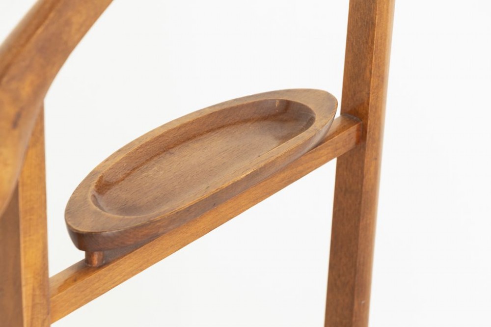 An Edwardian beech wood valet stand featuring a contoured coat hanger, small accessories dish, trouser bar, and a four-footed base on castors. View III